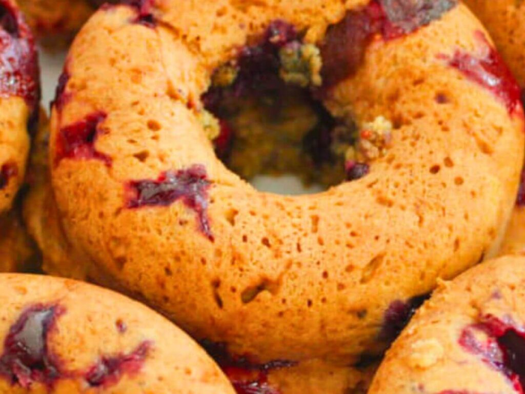 Close-up of a golden blueberry vegan donut with baked blueberries