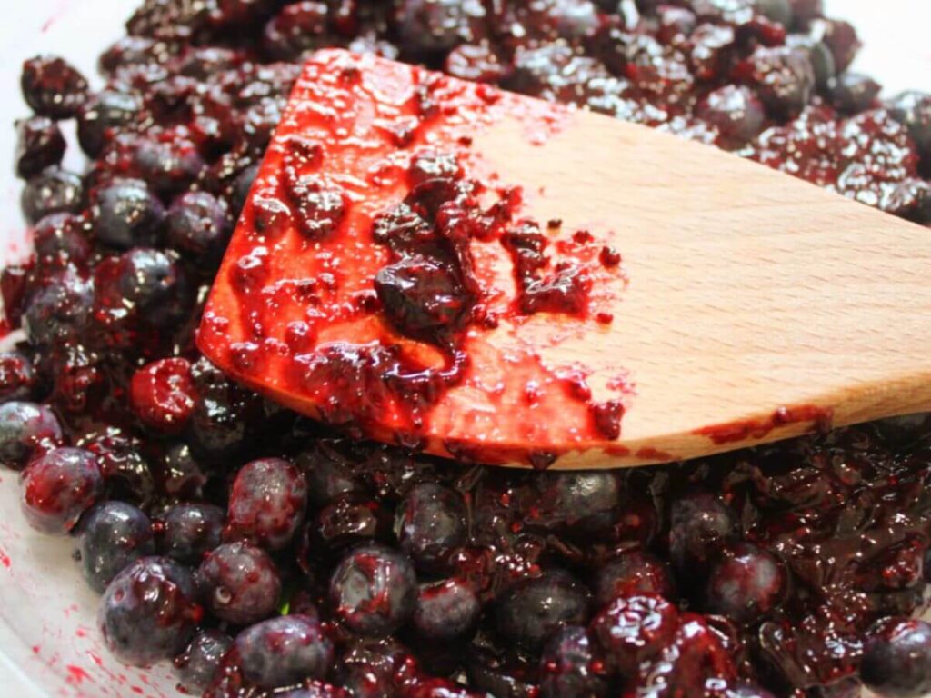 Bowl of fresh blueberries bursting with juice