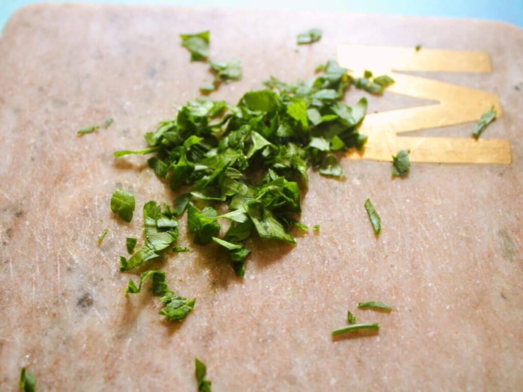 fresh chopped parsley on a cutting board for homemade rice a roni copycat