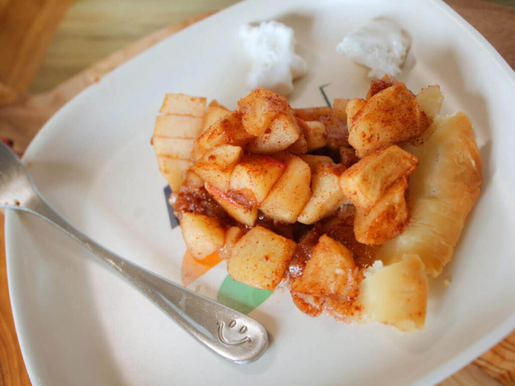 slice of vegan apple pie with dairy free whipped cream