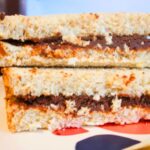 Chocolate sunflower seed butter spread thick on soft sandwich bread for a nut-free school lunch.