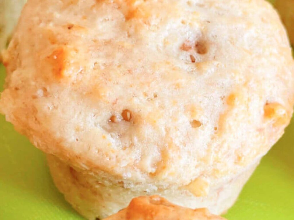 Single vegan banana walnut muffin showing soft texture and walnuts