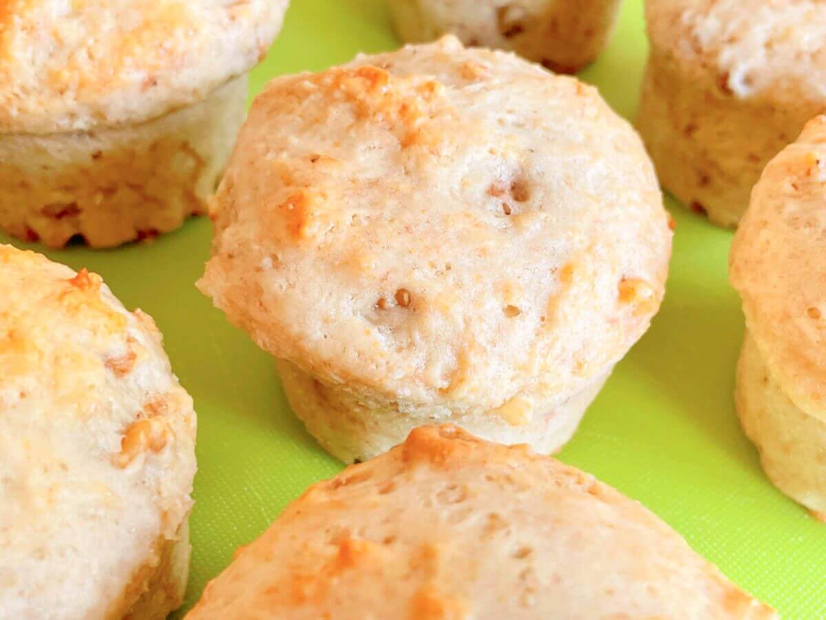 Overhead side view of golden vegan banana walnut muffins on a tray
