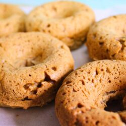 Chestnut vegan donuts cooling, lightly golden and baked, made with plant-based ingredients