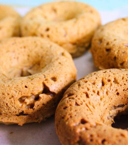 Chestnut vegan donuts cooling, lightly golden and baked, made with plant-based ingredients