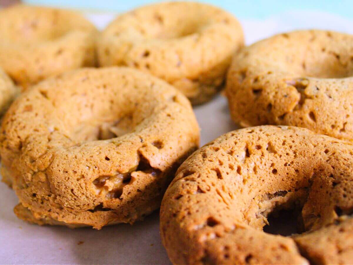 Chestnut vegan donuts cooling, lightly golden and baked, made with plant-based ingredients
