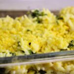 Side view of kid-friendly vegan broccoli cheddar rice served in a clear glass container.