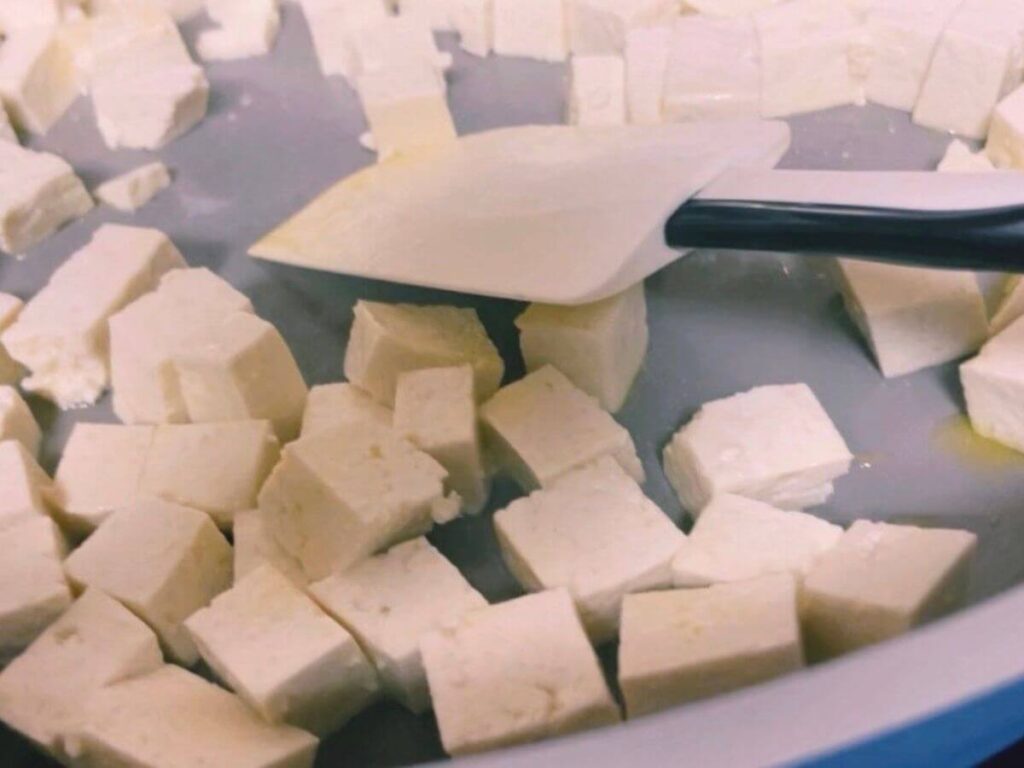 Tofu cubes prepared as an optional protein add-in for kid-friendly vegan broccoli cheddar rice.