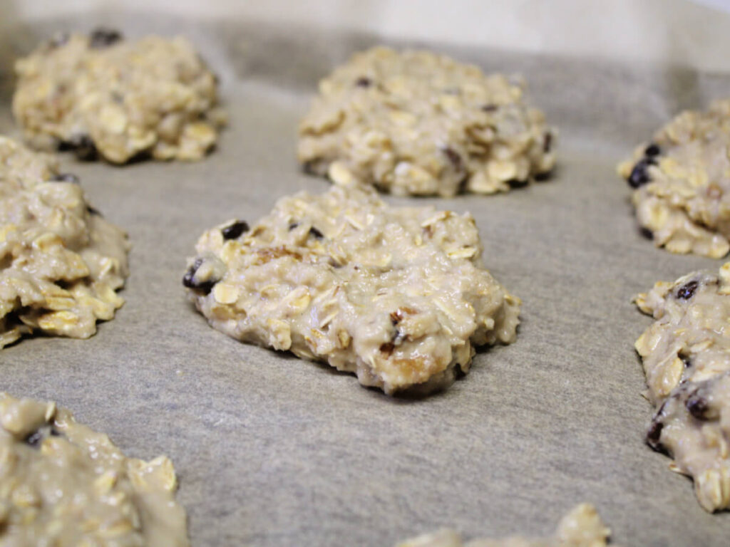 Flattened banana bread breakfast cookie dough on parchment paper