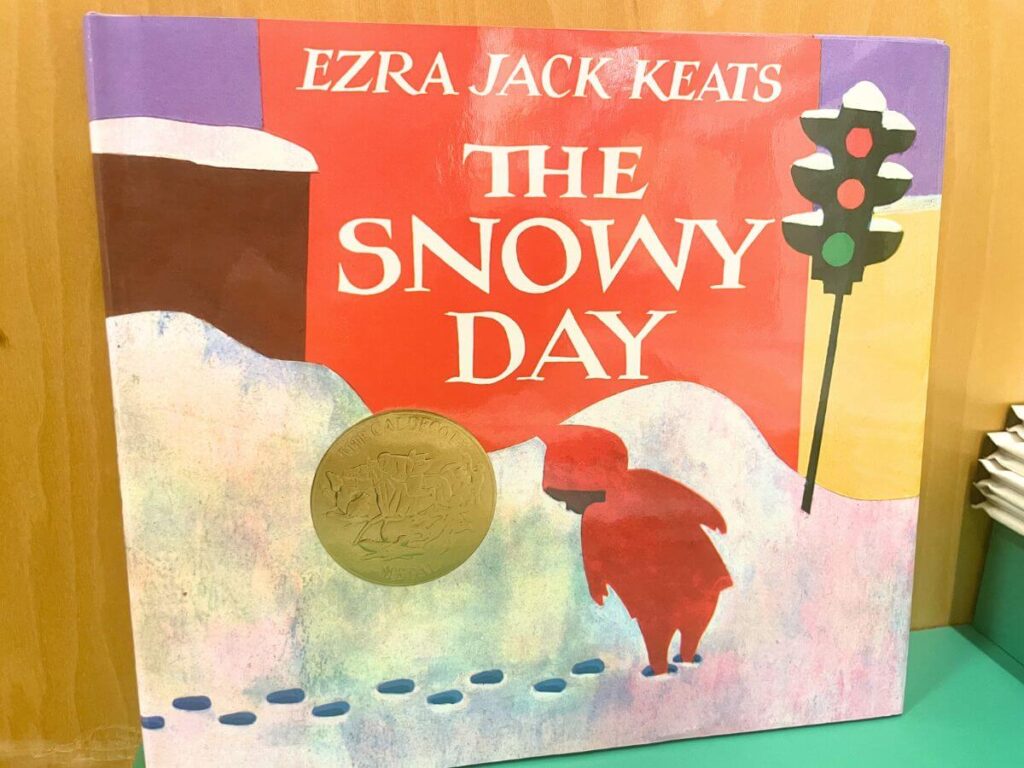 The Snowy Day book by Ezra Jack Keats on a snowy day