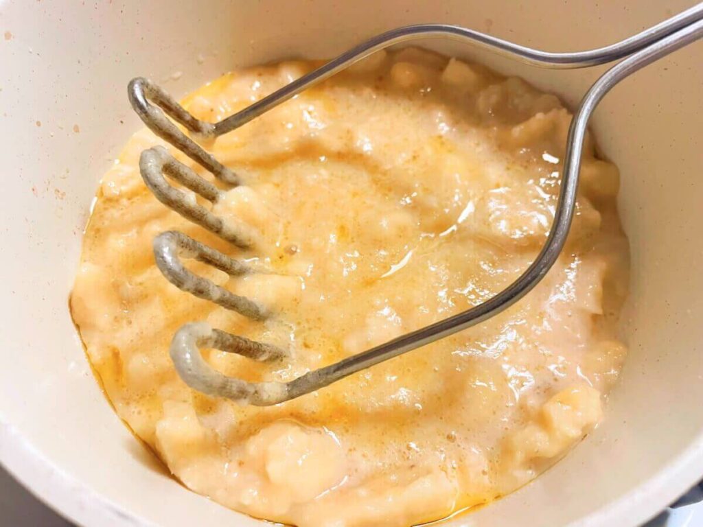 Mashed ripe bananas in bowl for vegan banana bread