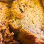 Close-up of sliced vegan banana bread with walnuts on top