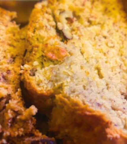 Close-up of sliced vegan banana bread with walnuts on top