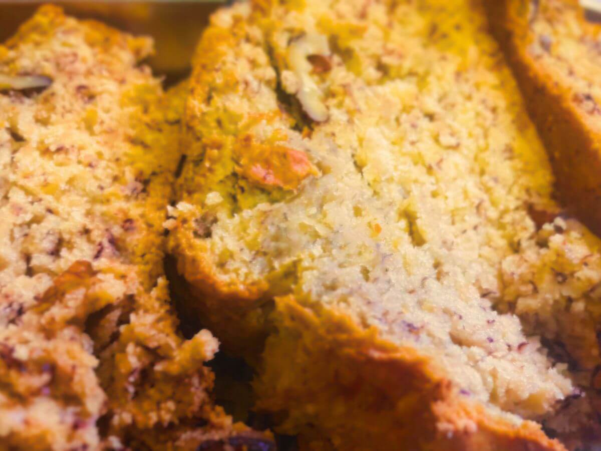 Close-up of sliced vegan banana bread with walnuts on top