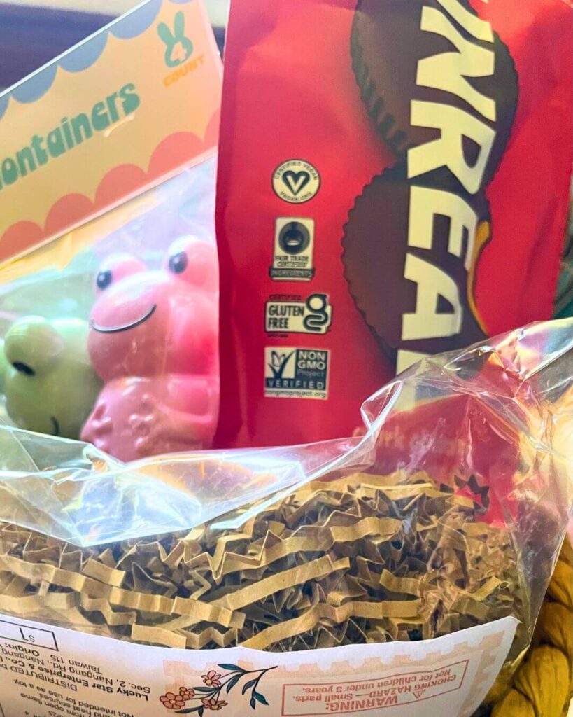 Vegan Easter basket for older kids filled with books, chocolate, games, and gift card