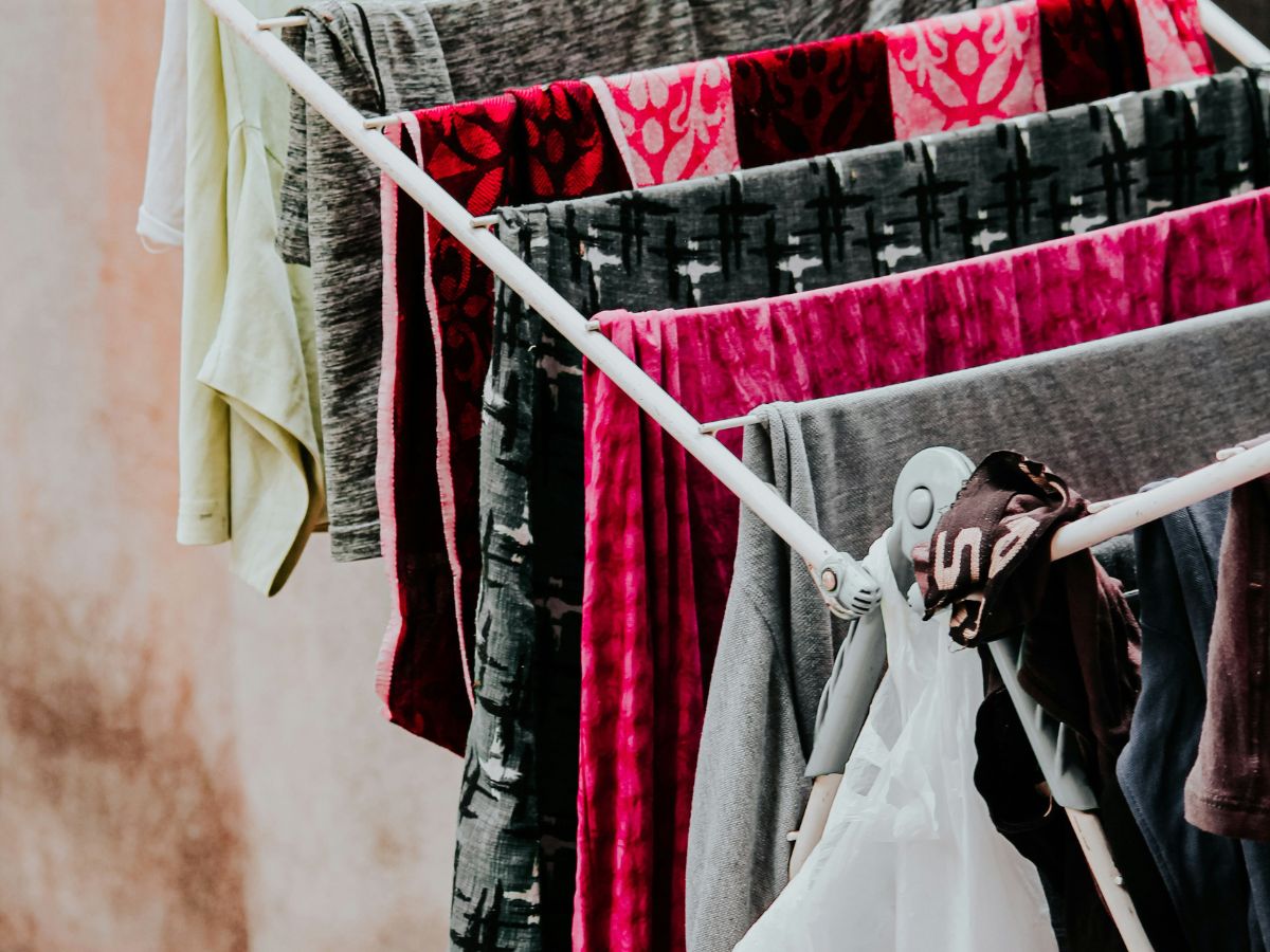 Clothes drying on a rack in natural light, reflecting simple, everyday modern homesteading at home.
