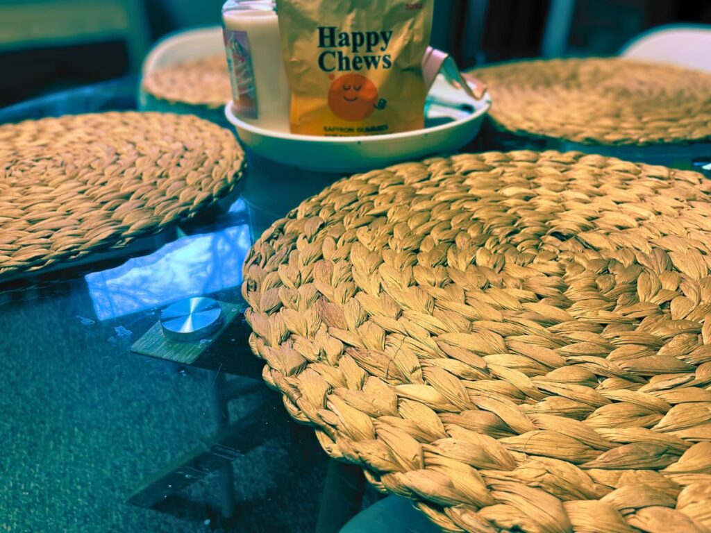 Close-up of a real dining table with placemats and everyday items, reflecting informal modern mealtime habits