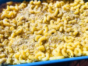 Close-up of vegan baked mac and cheese showing a creamy texture and soft pasta