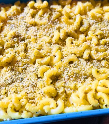 Close-up of vegan baked mac and cheese showing a creamy texture and soft pasta