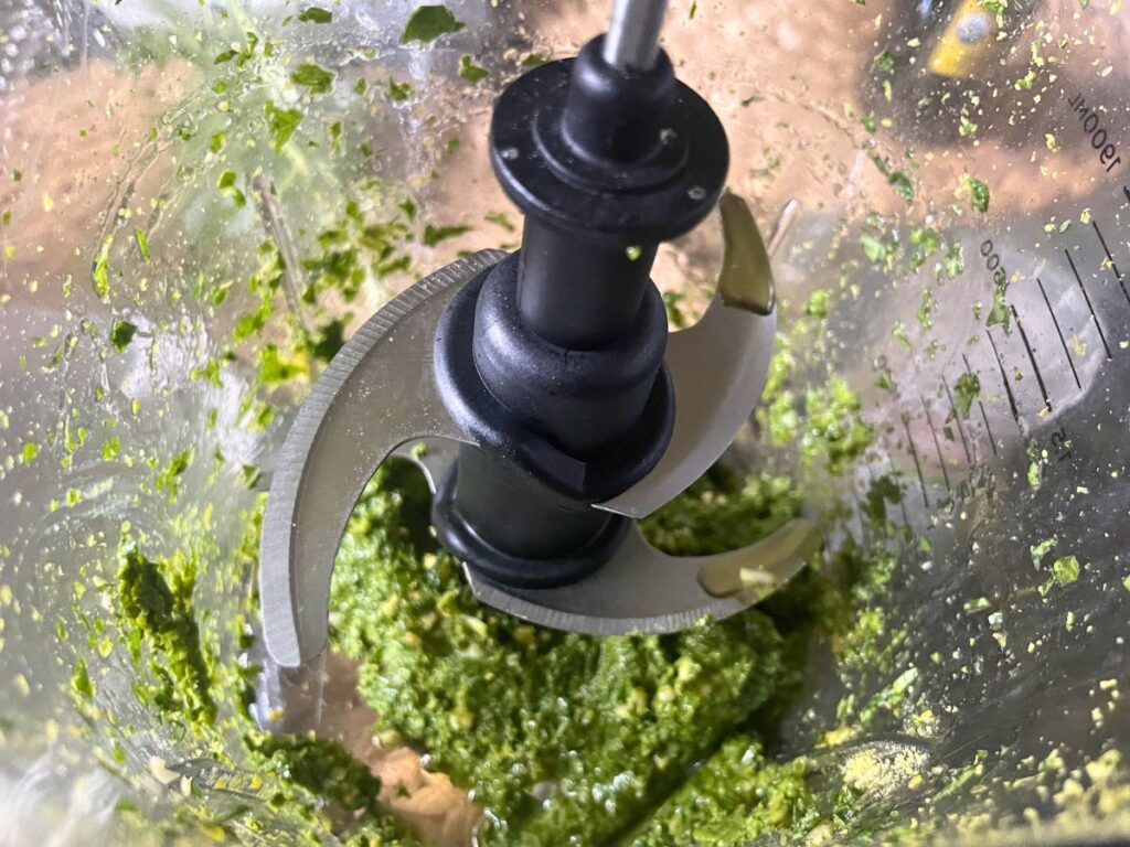 Vegan basil pesto blending in a high speed blender until smooth
