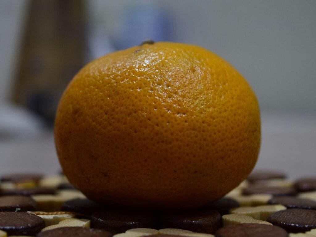 Whole orange on a kitchen counter representing not wasting food and using everything